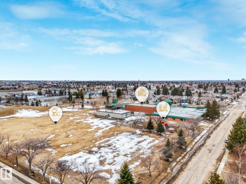 Aerial view showcasing the property's proximity to a paved road, open land, and surrounding buildings - 5904 84 Avenue, Edmonton, AB - Outdoor With View