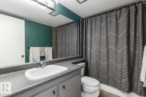 Bathroom featuring vanity, a shower with shower curtain, and tile patterned floors - 1207 12303 Jasper Avenue, Edmonton, AB - Indoor Photo Showing Bathroom