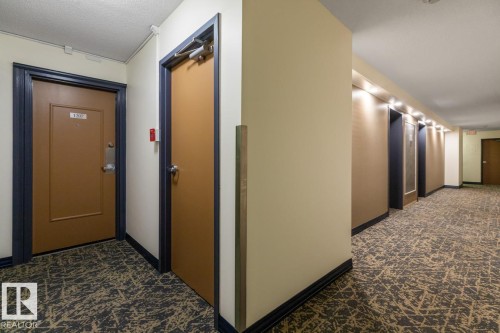 Hall with elevator and a textured ceiling - 1207 12303 Jasper Avenue, Edmonton, AB - Indoor Photo Showing Other Room