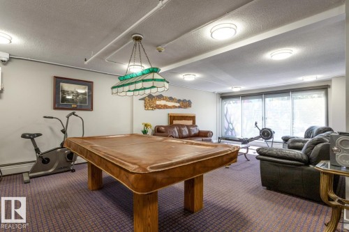 Rec room featuring a textured ceiling and billiards table - 1207 12303 Jasper Avenue, Edmonton, AB - Indoor Photo Showing Other Room