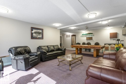 Living room featuring a textured ceiling and carpet - 1207 12303 Jasper Avenue, Edmonton, AB - Indoor Photo Showing Other Room