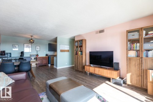 Living room featuring dark wood finished floors and baseboards - 1207 12303 Jasper Avenue, Edmonton, AB - Indoor Photo Showing Living Room