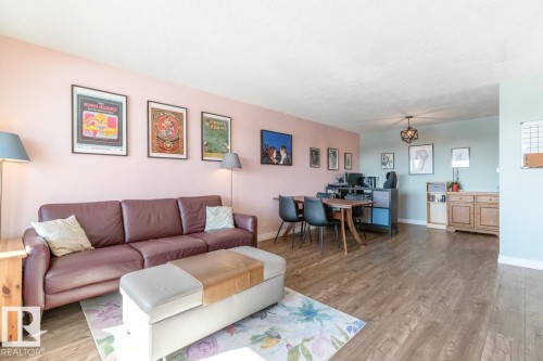 Living area with light wood-type flooring and baseboards - 1207 12303 Jasper Avenue, Edmonton, AB - Indoor Photo Showing Living Room