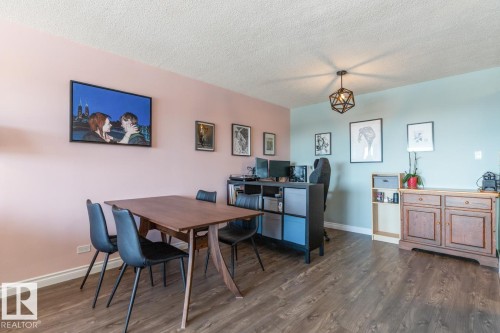 Dining space featuring dark wood-style flooring and a textured ceiling - 1207 12303 Jasper Avenue, Edmonton, AB - Indoor Photo Showing Dining Room