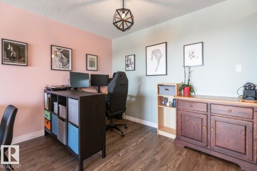 Home office featuring dark wood-type flooring and a textured ceiling - 1207 12303 Jasper Avenue, Edmonton, AB - Indoor Photo Showing Office