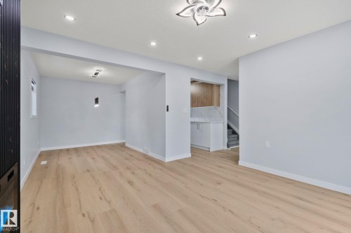 The property features light wood flooring throughout, light-colored walls, and recessed lighting - 8620 38A Avenue, Edmonton, AB - Indoor Photo Showing Other Room