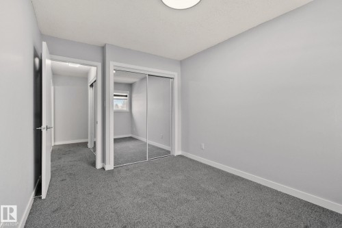 This room features light grey walls and a dark grey carpet - 8620 38A Avenue, Edmonton, AB - Indoor Photo Showing Other Room