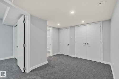 The property features light gray walls, white trim, and gray carpet - 8620 38A Avenue, Edmonton, AB - Indoor Photo Showing Other Room