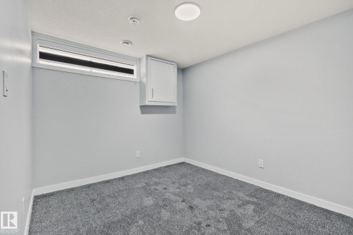 This room features grey carpeting, light grey walls, and a window with blinds - 8620 38A Avenue, Edmonton, AB - Indoor Photo Showing Other Room
