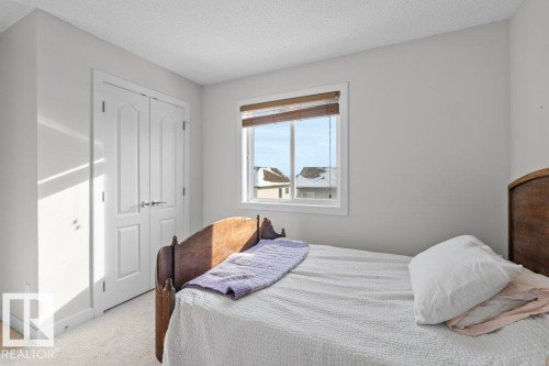 Bedroom featuring light-colored walls, a window with horizontal blinds, and carpeted flooring - 1227 Secord Landing, Edmonton, AB - Indoor Photo Showing Bedroom
