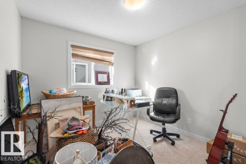 Room with light-colored walls and carpeting, featuring a window with blinds, and a ceiling light fixture - 1227 Secord Landing, Edmonton, AB - Indoor Photo Showing Other Room