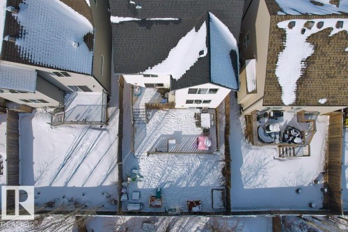 The property features a fenced backyard with a raised deck and a patio area - 1227 Secord Landing, Edmonton, AB - Outdoor