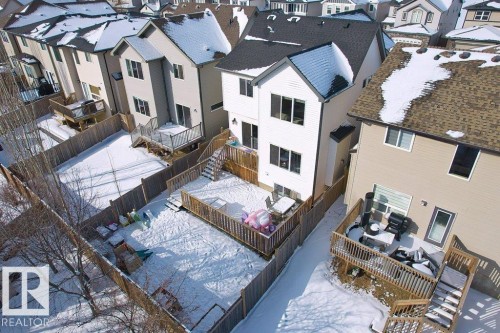 The property features a private backyard with a wooden fence and a raised wooden deck - 1227 Secord Landing, Edmonton, AB - Outdoor