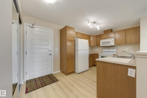 404 6070 Schonsee Way, Edmonton, AB - Indoor Photo Showing Kitchen With Double Sink
