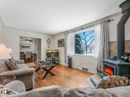 7653 91 Avenue, Edmonton, AB - Indoor Photo Showing Living Room With Fireplace