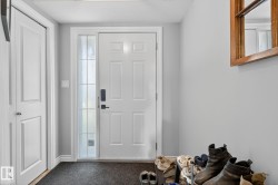 Inviting entryway featuring a paneled door with a sidelight, painted in a crisp white - 