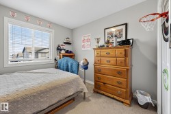 This room features a window with blinds, light gray painted walls, and carpeted flooring - 