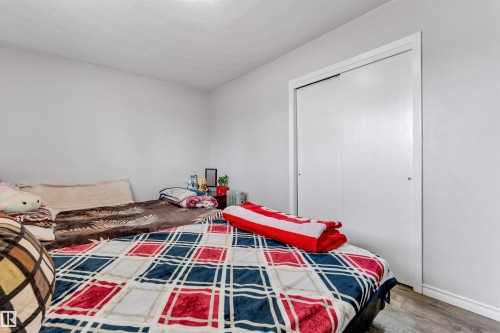 The property features a room with light-colored walls and a closet with white sliding doors - 12908 126 Street, Edmonton, AB - Indoor Photo Showing Bedroom