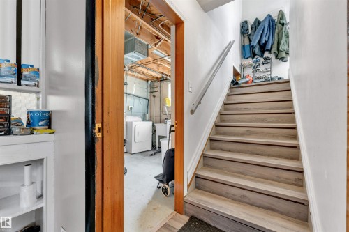 The property includes a utility area with a washer and dryer, visible through a doorway with a wooden frame - 12908 126 Street, Edmonton, AB - Indoor Photo Showing Other Room