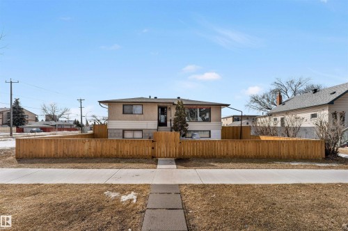 The property features a wood fence and a concrete walkway leading to the entrance - 12908 126 Street, Edmonton, AB - Outdoor