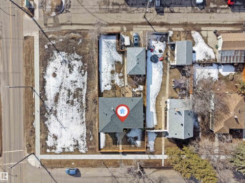 Aerial view of the property and surrounding neighborhood, featuring a gray shingled roof and a paved street - 12908 126 Street, Edmonton, AB - Outdoor