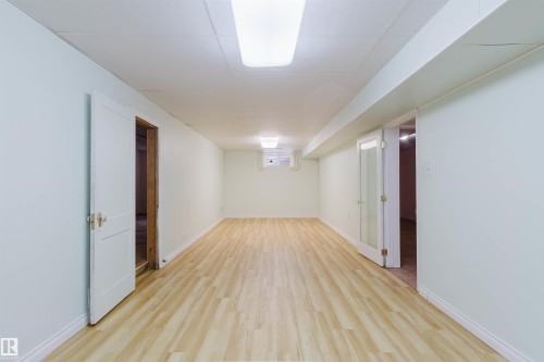 Spacious room with light-colored flooring, neutral walls, and overhead lighting - 11815 76 Avenue, Edmonton, AB - Indoor Photo Showing Other Room