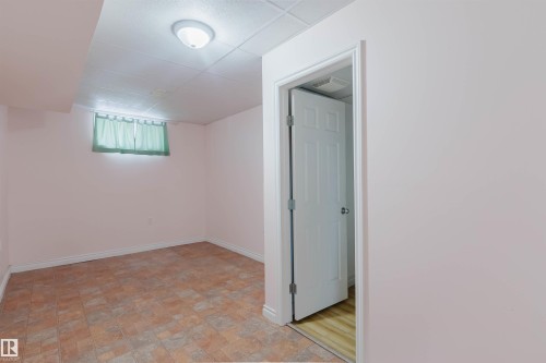 Room featuring tiled flooring, a drop ceiling, and a light fixture - 11815 76 Avenue, Edmonton, AB - Indoor Photo Showing Other Room