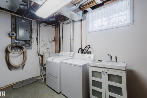 The property includes a dedicated laundry area with a washer, dryer, and utility sink - 11815 76 Avenue, Edmonton, AB - Indoor Photo Showing Laundry Room