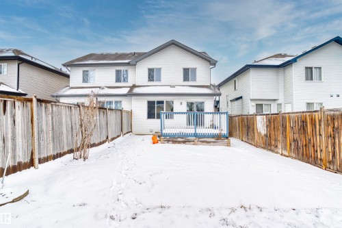 The property features a private backyard with a wooden fence and a deck, providing outdoor living space - 11542 18A Avenue, Edmonton, AB - Outdoor With Deck Patio Veranda With Exterior