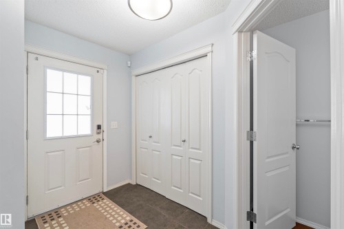 Entryway featuring a white door with a window, a bi-fold closet, and durable tile flooring - 11542 18A Avenue, Edmonton, AB - Indoor Photo Showing Other Room