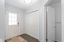 Entryway featuring a white door with a window, a bi-fold closet, and durable tile flooring - 11542 18A Avenue, Edmonton, AB  - Indoor Photo Showing Other Room 