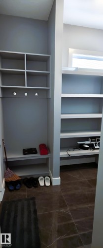 This area features built-in shelving and storage, with a space for hanging items - 1781 Melrose Crescent, Edmonton, AB - Indoor