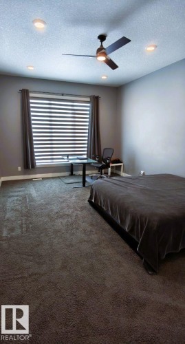 This room features a ceiling fan, recessed lighting, and a window with blinds and curtains - 1781 Melrose Crescent, Edmonton, AB - Indoor Photo Showing Other Room