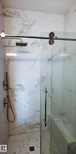 The shower features a rain showerhead, a handheld shower fixture, and a built-in bench - 1781 Melrose Crescent, Edmonton, AB - Indoor Photo Showing Bathroom