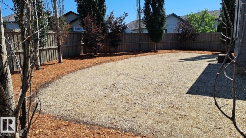 The property features a large, level gravel area with surrounding mulch beds - 1781 Melrose Crescent, Edmonton, AB - Outdoor