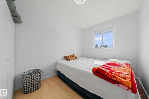 This room features light-colored walls and light wood flooring, creating a bright atmosphere - 5418 17A Avenue, Edmonton, AB - Indoor Photo Showing Bedroom