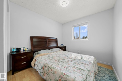 This room features light-colored walls and light wood flooring - 5418 17A Avenue, Edmonton, AB - Indoor Photo Showing Bedroom
