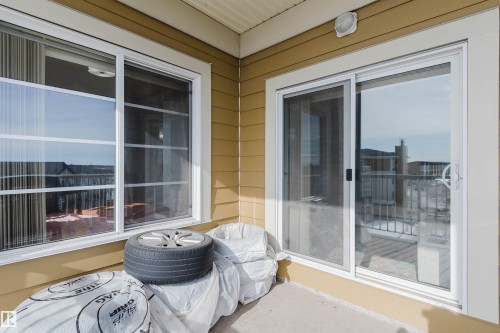 The property features a balcony with sliding glass doors and an exterior wall with horizontal siding - 402 3670 139 Avenue, Edmonton, AB - Outdoor With Balcony With Exterior