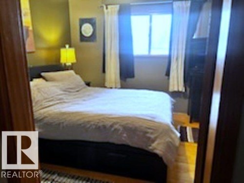 This room features wood flooring and a window with curtains - 243 Lynnwood Way, Edmonton, AB - Indoor Photo Showing Bedroom