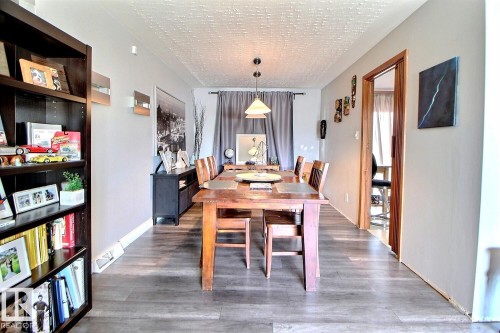 The property features a dining area with wood-style flooring and light grey walls - 243 Lynnwood Way, Edmonton, AB - Indoor Photo Showing Dining Room