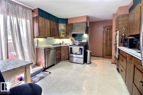 This kitchen features ample wooden cabinetry, a stainless steel dishwasher, and a stainless steel oven - 243 Lynnwood Way, Edmonton, AB - Indoor Photo Showing Kitchen