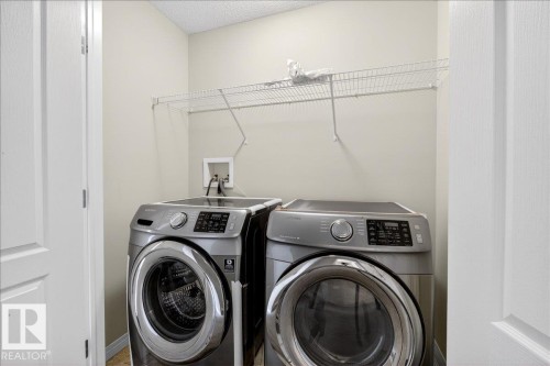 Second floor Dedicated laundry area with a wire shelving unit. next to upstairs bedrooms. - 17023 38 Street Nw, Edmonton, AB 
