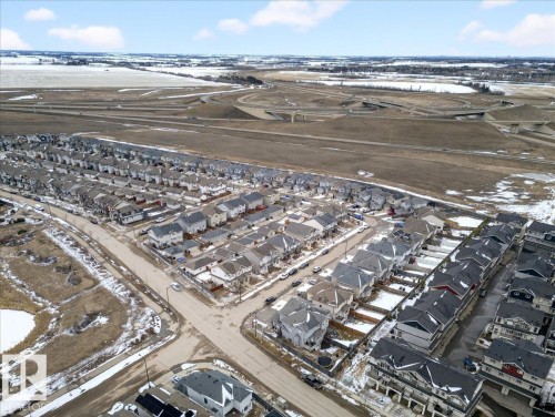 Aerial view of the community, showcasing streets, residential properties, and surrounding fields - 17023 38 Street Nw, Edmonton, AB - Outdoor With View