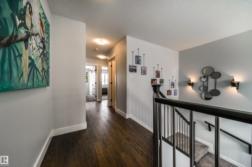 The property features dark hardwood flooring in the hallway - 3514 49 Avenue, Beaumont, AB - Indoor Photo Showing Other Room