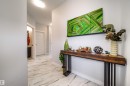The property features a hallway with white walls and light-toned, patterned floor tiles - 3514 49 Avenue, Beaumont, AB  - Indoor Photo Showing Other Room 