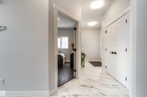 Entryway featuring light-toned walls, white trim, and white paneled doors with dark hardware - 3514 49 Avenue, Beaumont, AB - Indoor Photo Showing Other Room