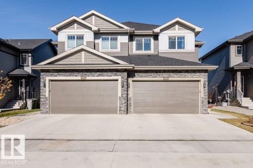 The property features a two-story exterior with a combination of siding and stone detailing - 3514 49 Avenue, Beaumont, AB - Outdoor With Facade