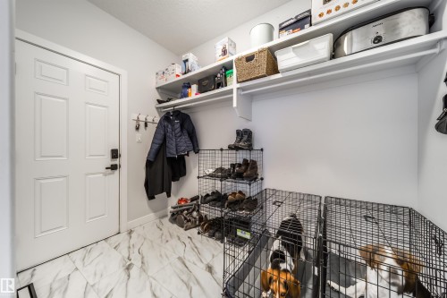 This space features white walls, white paneled door, and white marbled tile flooring - 3514 49 Avenue, Beaumont, AB - Indoor Photo Showing Other Room
