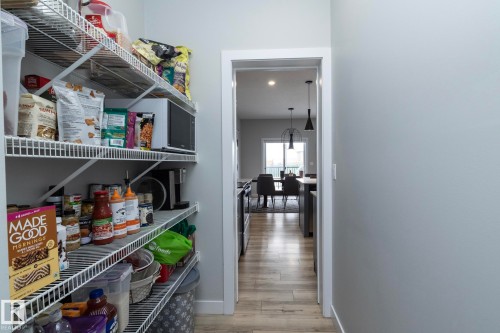 The property features a well-organized pantry with wire shelving, offering practical storage solutions - 20650 94A Avenue, Edmonton, AB - Indoor