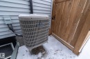 The property includes a visible exterior air conditioning unit and light-colored siding - 20650 94A Avenue, Edmonton, AB  - Outdoor With Exterior 